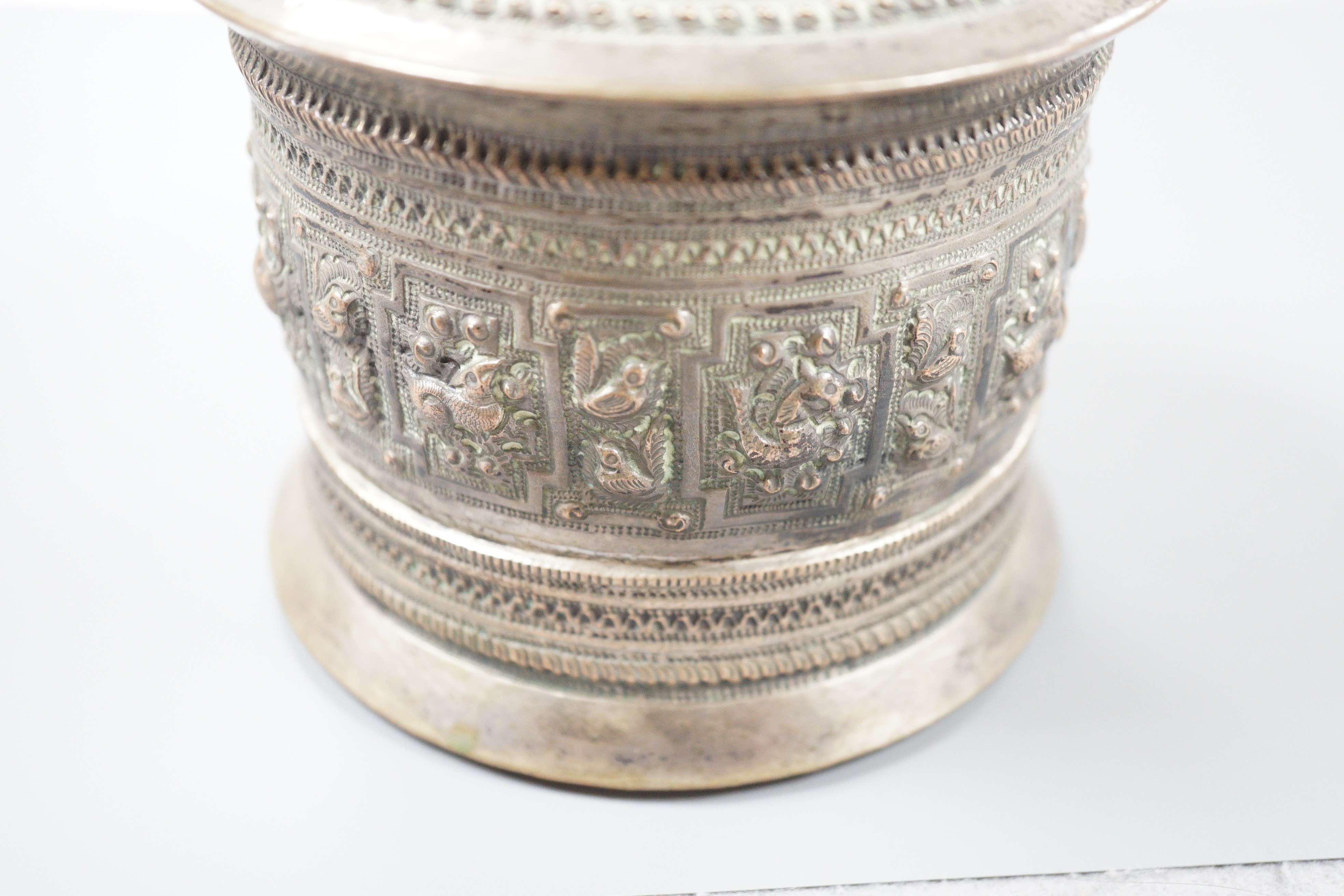 A 19th century Shan people white metal circular betel box and cover, Eastern Burma, height 10.5cm, 266 grams.